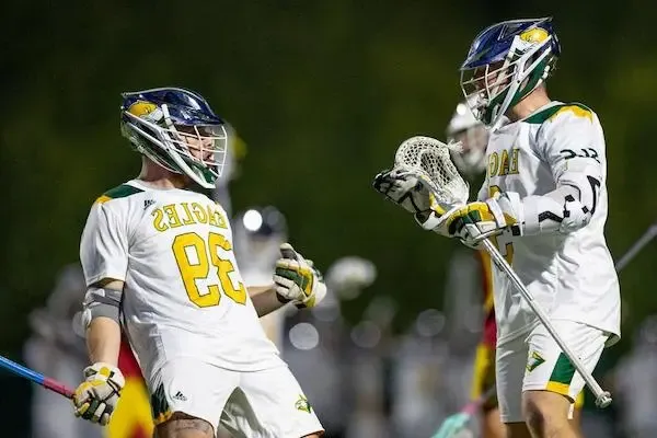Two lacrosse players cheering